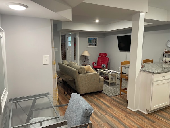 Living Area has seating area, desk, and a nook with a futon for double bet