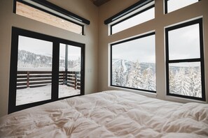 The primary bedroom enjoys world class views. Open the blinds with a remote. 