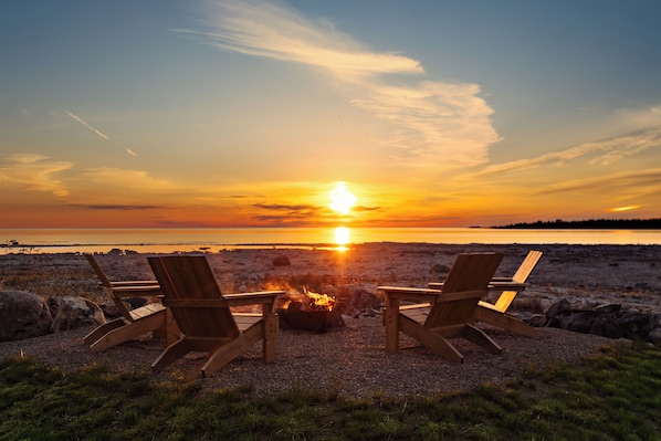 Immerse yourself in breathtaking Lake Huron views. This 1.1-acre property feels like an island retreat, with the sounds of nature. Enjoy a spacious backyard, a separate fire pit, and the best sunset spot in Tobermory.