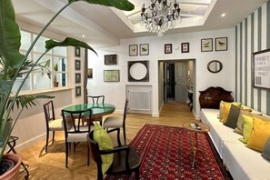 Living room with dining table and two single sofa beds 