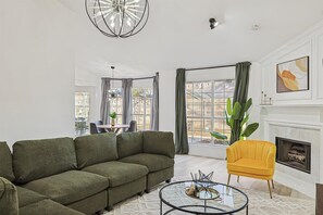 With vaulted ceilings and thoughtful furnishings to create a warm and comfortable atmosphere, this living room will invite you to sit and stay a while. 
