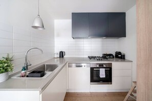 In the kitchen, you’ll find everything you need to prepare meals at home on sleek appliances and cooking utensils.