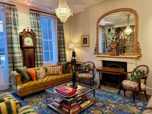 Green Drawing Room Lounge with sofas, armchairs and Sonos music player