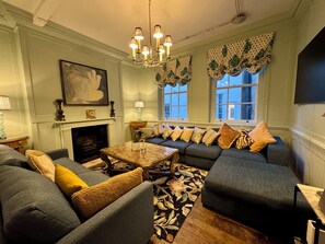 Blue TV  Family Room with large sofas and 65 inch smart TV & Sonos music player