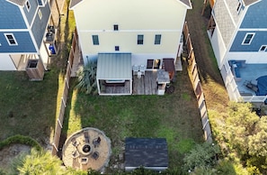 Backyard oasis awaits with fire pit, patio, outdoor shower, and hot tub