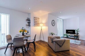 The open-plan living room, dining area and kitchen benefit from a comfortable sofa and 40-inch SMART TV.