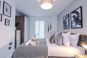 Bedroom 1 benefits from a comfortable double bed, plenty of storage and an en-suite bathroom with a toilet, sink and shower cubicle.