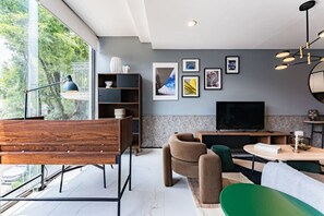 Bright and welcoming living area with floor-to-ceiling windows, perfect for soaking in the natural light and lush views.
