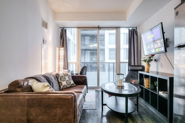 Spacious and cozy living room with comfortable seating and a Smart TV for your entertainment.