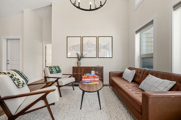 Beautifully designed living room on the main floor with cozy seating and plenty of natural lighting.