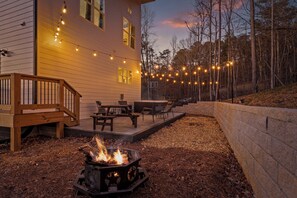 Back Patio with Hot Tub, String Lights, Dining Area, and Chairs (1)
