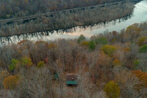 A breathtaking bird's-eye view of the serene Riverwood Retreat, where nature and tranquility surround you.