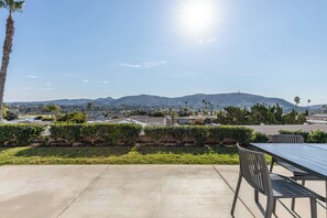 Enjoy a sun-drenched backyard with patio, dining area and mountain views