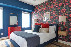 The bold floral accent wall injects the space with personality