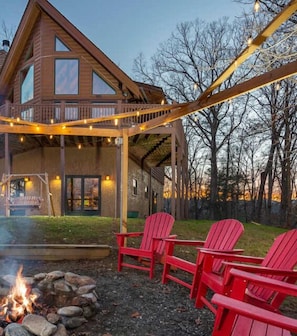 Create unforgettable memories around the firepit, nestled outside the cabin and illuminated by twinkling lights.