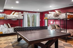 Play, rest, repeat—our ping pong table and double-sized bunk beds have you covered!
