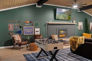 Enjoy fun and warmth with a foosball table and an inviting indoor fireplace in the heart of the living room