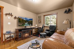 Our living room is complete with a cozy couch and a crackling fireplace.