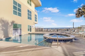 Outdoor swim thru pool with hot tub