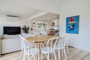 Share meals around the spacious, eight-seater dining table, with additional seating available at the breakfast bar.