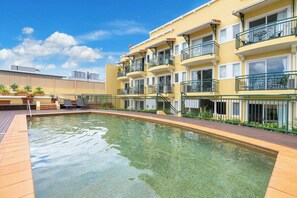 Cool off in the shared pool, surrounded by a sun deck perfect for lounging and enjoying the tropical atmosphere.