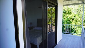 View from balcony to master bedroom, balcony has a seating area as well