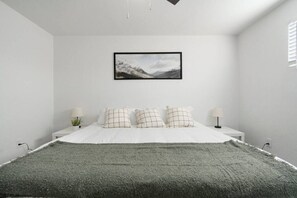 You feel a sense of serenity as you step into the king bedroom, where the elegant design and comfortable bed invite relaxation.