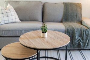 You feel a sense of peace as you step into the living room , with its inviting decor and soothing tones.