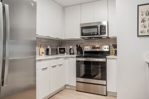 Fully equipped kitchen with all the tools you need for a perfect culinary experience. Enjoy the convenience of having everything at your fingertips!
