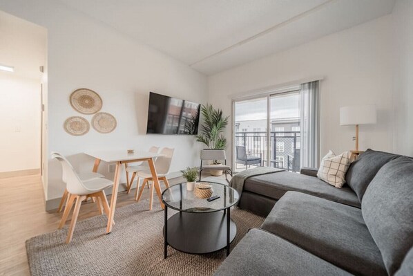 The living room’s cozy vibe makes it the perfect spot to relax, with ample seating and a warm ambiance.