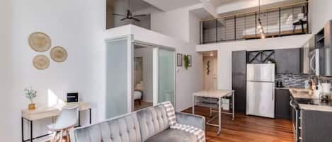 The living room is filled with natural light, creating a bright and welcoming space that invites relaxation.
