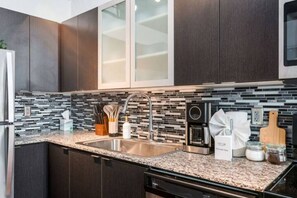 As you open the kitchen, you discover an assortment of coffee pods, and sugar, ensuring you have everything you need for a perfect morning or afternoon pick-me-up.