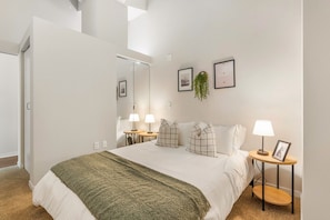 The bedroom’s serene ambiance invites you to relax, with a plush bed that promises a restful night's sleep.