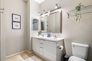 You feel a sense of calm as you enter the bathroom, where the thoughtful design and high-quality materials create a serene environment.
