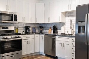 As you open the kitchen, you discover an assortment of coffee pods, and sugar, ensuring you have everything you need for a perfect morning or afternoon pick-me-up.