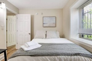 The bedroom’s serene ambiance invites you to relax, with a plush bed that promises a restful night's sleep.