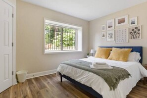 The queen bedroom’s stylish design and comfortable bedding create a perfect sanctuary for restful nights.