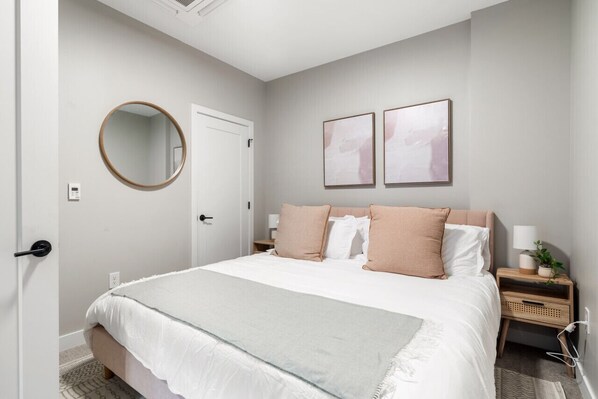 You feel enveloped in comfort as you relax on the queen bed, surrounded by a room designed for tranquility.