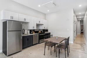 The kitchen’s open layout allows you to move freely as you prepare meals, with everything you need at your fingertips.