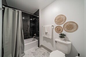 You feel a sense of calm as you enter the bathroom, where the thoughtful design and high-quality materials create a serene environment.