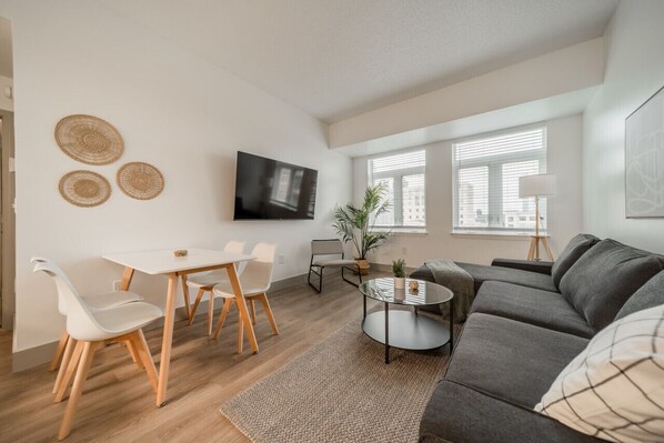 The living room is filled with natural light, creating a bright and welcoming space that invites relaxation.