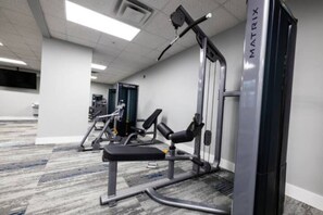 Open floor area with exercise mats, yoga balls, and foam rollers for warm-ups, stretching, or core exercises.