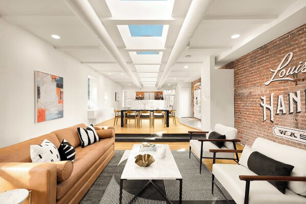 Relax in the spacious living room, where open, airy design meets the timeless stories of Washington’s well-to-do and their trusted Laundry.