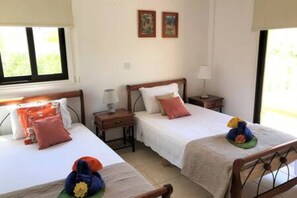 Bedroom 3. The twin room with a balcony overlooking the pool.