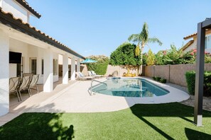 This beautiful, fully-fenced back yard has a heated pool, BBQ grill, gas firepit, putting green, corn toss and plenty of seating!