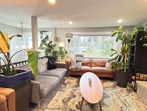 Living room with a 72” smart TV and cozy fireplace 