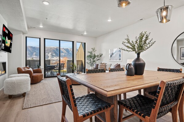 The open-concept living space, complete with a dining area, facilitates effortless conversation with family and friends.