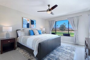 Main bedroom with king bed, patio access, and golf course view