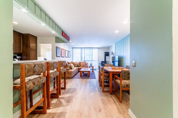 Open living area with kitchen, dining area and living room.