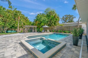 Pool and spillover spa with the patio pergola in the background.